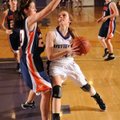Sarah Smith, center, a Fayetteville junior guard, makes a move to the basket as Rogers Heritage soph...