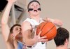 Bentonville’s Austin Haggard, center, takes the ball to the basket between Fort Smith Southside’s Sam Ross, left, and John Hunton during the Tigers’ game Tuesday against the Rebels in Bentonville.