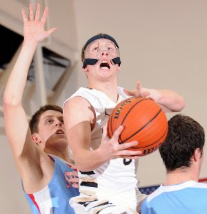 Bentonville’s Austin Haggard, center, takes the ball to the basket between Fort Smith Southside’s Sam Ross, left, and John Hunton during the Tigers’ game Tuesday against the Rebels in Bentonville.