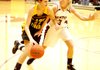 Gentry's Tara Arnold (right) guards against Prairie Grove's Justyne Huber during play in Gentry on Friday night, following colors day ceremonies.