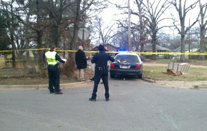 Police investigate the scene of a Little Rock shooting Wednesday at West 19th and South Brown Streets. 