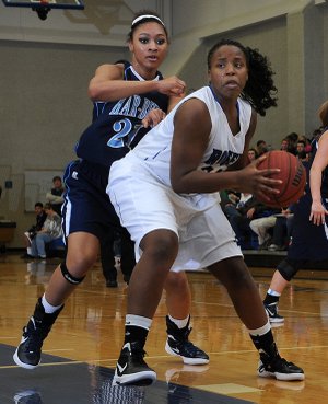 Springdale Har-Ber’s Summer Morgan, left, can’t keep up with Rogers High’s Taylor Strickland on Tuesday as Strickland drives past Morgan in the first half of the game at King Arena in Rogers. The Lady Mounties won the game, 57-54.