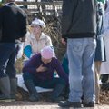 A Cargill Turkey Plant worker comforts another worker affected by an ammonia leak Monday at the Rand...