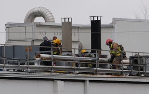 Firefighters on the roof of a Tyson research facility Wednesday morning.