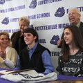 Colton Cheek, center, a Fayetteville boys’ tennis player, signs his national letter of intent with J...