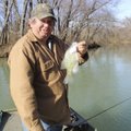 Mike McBride shows one of several crappie he caught from the White River above Lake Sequoyah last Fr...