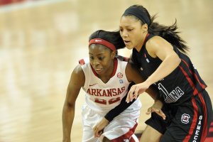 Arkansas guard C’eira Ricketts and South Carolina’s La’ Keisha Sutton chase down a loose ball during the first half of Thursday’s game at Walton Arena in Fayetteville.