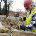 ROCK WORK Mark Caldwell of Caldwell Stone in Fayetteville cuts a piece of native stone Thursday to f...