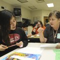 WORKING TOGETHER Evelyn Flores, left, Elmwood student, works with Walmart associate Terry Hankins du...