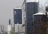 Smoke is seen Friday coming from the top of one of the silos at the AERT plant in Springdale.