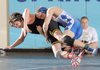 Jake Humphries, right, Rogers High, and Bentonville’s Aaron Grigsby compete in the championship bout for the 120-pound division Saturday during the 7A-West Conference wrestling meet at Har-Ber High School in Springdale.
