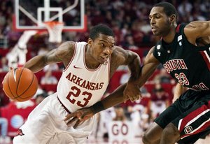 Arkansas' Julysses Nobles (23) drives around South Carolina's R.J. Slawson (33) during the first half of an NCAA college basketball game in Fayetteville, Ark., Saturday, Feb. 11, 2012. Arkansas won 76-65. (AP Photo/April L. Brown)