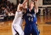 Nathan Musso, Rogers High senior forward, takes a shot in the lane past Fayetteville junior post Tyler McCullough, left, Friday during the second half in Fayetteville.
