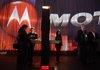 In this Jan. 10, 2012 file photo, industry affiliates examine various apps on Motorola tablets during the 2012 International CES tradeshow, in Las Vegas. The EU's antitrust watchdog has approved Google's $12.5 billion takeover of cell phone maker Motorola.