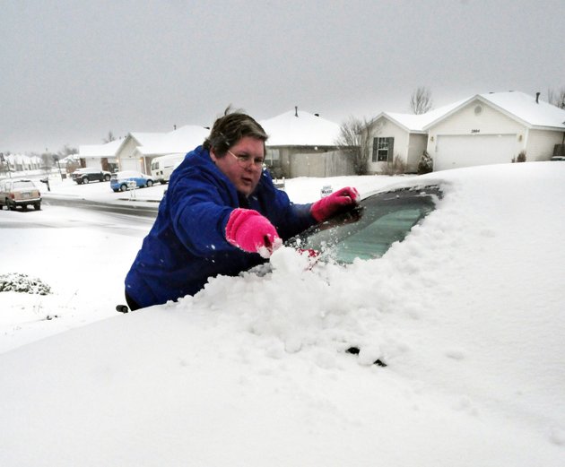 pam-chastain-scrapes-the-snow-off-the-windshield-of-her-car-as-the-area-gets-its-first-snowfall-of-the-year-chastain-who-works-at-a-local-chicken-plant-said-that-she-works-even-on-bad-days-because-of-the-production-line