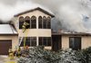 Volunteer Firefighter from Hickory Creek, Nob Hill and Pleasure Heights work to enter the upper floor of a house on Hickory Lane in Hickory Creek, Monday Feb. 13, 2012 to reach a fire.