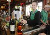 April Smith checks out a customer buying alcohol at Macadoodles in Jane, Mo., on Friday. A drive is under way in Benton County to place retail alcohol sales on the ballot in November.
