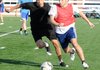 Joe Henson, left, and Cole Brothers, run after the ball Thursday during practice at Springdale Har-Ber High School. The team’s first game is Friday against LISA Academy.