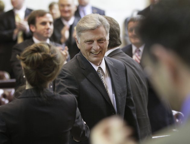 arkansas-gov-mike-beebe-center-is-greeted-by-legislators-as-he-walks-through-the-house-chamber-at-the-arkansas-state-capitol-in-little-rock-ark-monday-feb-13-2012