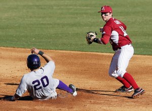Arkansas Democrat-Gazette/WILLIAM MOORE
Arkansas shortstop Tim Carver holds his throw to first as Northwestern State's Nick Hinojos slides into second to break up a double-play Tuesday, February 21, 2012 at Baum Stadium in Fayetteville.