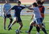 Brenda Bernal, center, tries to kick the ball Tuesday before Stephanie Berganza, from right, and Marria Gonzales can get to it during practice at Springdale Har-Ber High School. The Lady Wildcats open their season Friday against LISA Academy.