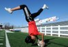 Martha Trujillo, a Springdale High School senior, performers a “flipper,” where she flips to throw the ball in bounds.