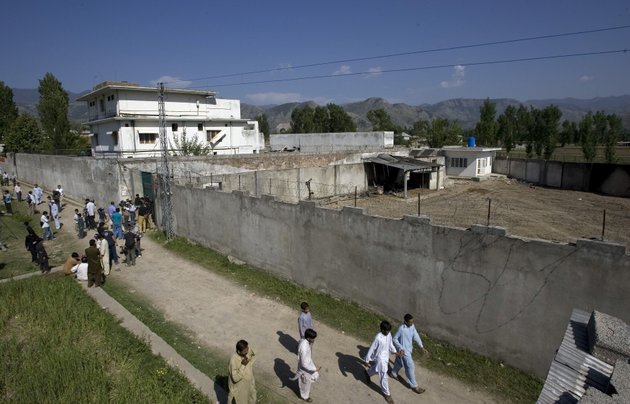 in-this-this-may-3-2011-file-photo-media-and-local-residents-gather-outside-the-compound-where-al-qaida-leader-osama-bin-laden-was-caught-and-killed-in-abbottabad-pakistan