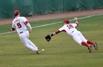 University of Arkansas third baseman Matt Reynolds tries to avoid running into diving short stop Tim Carver as they go after a shallow fly ball in the 2nd inning of Tuesday afternoon's game at Baum Stadium in Fayetteville. 