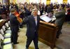 Gov. Mike Beebe greets legislators as he enters the house chamber at the start of the fiscal session Feb. 13. The session drew to a close Friday, March 2.