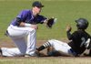 Austin Allen, left, Fayetteville shortstop, reaches to field the late throw from the plate Saturday as Little Rock Central courtesy runner Larry Johnson comes in safely at second during the third inning of play at Fayetteville High School.
