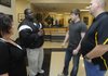 Austin Gonzalez, second from right, Bentonville wrestler, talks with Ken Prophete, left, wrestling coach at Central Baptist College in Conway, on Wednesday at Tiger Athletic Complex in Bentonville. Prophete told Gonzalez what he needs to do during the summer to stay in shape while his mother, Tracy Unger, and Bill Desler, wrestling coach at Bentonville, listen. Gonzalez signed a letter of intent Wednesday to wrestle at Central Baptist College.