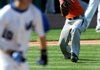 Cameron Besett, Rogers Heritage’s pitcher, throws to first off a bunt hit by Rogers High’s Austin Griffen on Thursday at Arvest Ballpark in Springdale. Rogers Heritage won 6-3.