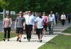 Participants in the Little Rock River Market section of Downtown Partnership’s new Monday Mile walking program stride April 2 through the Clinton Presidential Park in Little Rock. 
