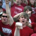 Tyler Grant, a freshman at the University of Arkansas, joins fans in a Hog call during a rally Monda...
