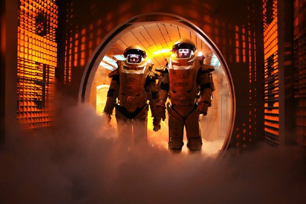 emilie-maggie-grace-and-snow-guy-pearce-don-futuristic-orange-suits-in-an-attempt-to-escape-from-space-prison-in-the-science-fiction-thriller-lockout