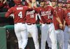 Arkansas Democrat-Gazette/MICHAEL WOODS --04/13/2012-- Arkansas center fielder Jacob Morris is congratulated by teammates after scoring a run in the third inning of Friday night's game against Kentucky at Baum Stadium in Fayetteville.