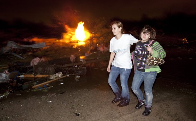 two-people-walk-past-a-gas-fire-in-the-pinaire-mobile-home-park-in-wichita-kansas-on-saturday-april-14-2012-after-a-tornado-caused-massive-destruction-in-the-area-on-saturday-night