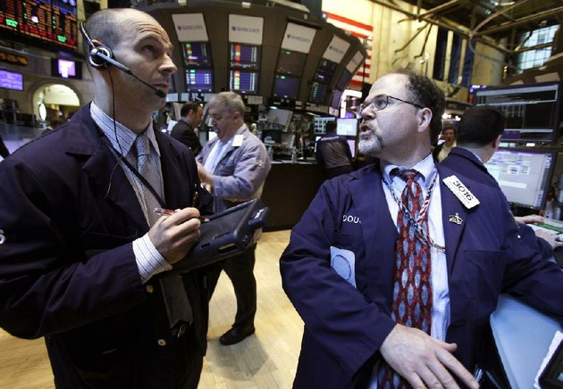 specialist-douglas-johnson-right-works-at-his-post-on-the-floor-of-the-new-york-stock-exchange-on-monday