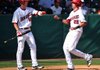 Arkansas Democrat-Gazette/MICHAEL WOODS - 04/17/2012 - Arkansas first baseman Dominic Ficociello is greeted by teammate Conor Costello after scoring a run in the fourth inning of Tuesday afternoon's game against Stephen F. Austin at Baum Stadium in Fayetteville.