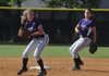 Fayetteville’s Sara Wilson, left, tries to throw out a Bentonville batter on Thursday in Bentonville as teammate Taylor Crockett moves to cover second. 