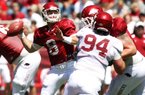 Arkansas quarterback Tyler Wilson avoids the defense for a first-half pass in the Red’s 65-0 victory Saturday. Wilson completed 31 of 41 passes for 467 yards and 2 touchdowns in the game-style scrimmage.