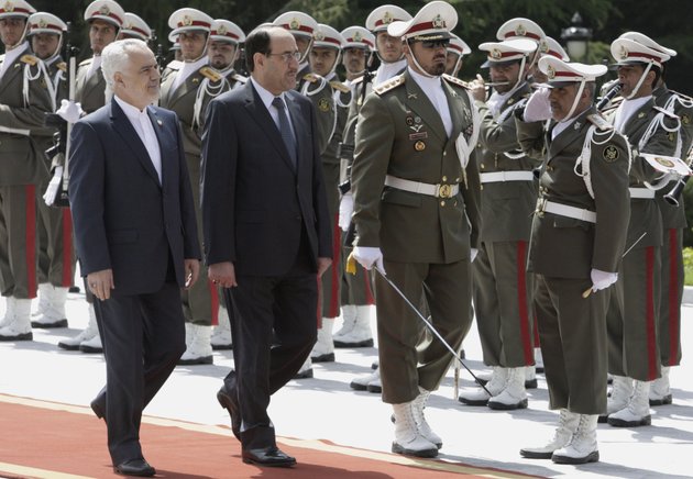 iraqi-prime-minister-nouri-al-maliki-center-reviews-an-iranian-honor-guard-as-he-is-accompanied-by-iranian-vice-president-mohammad-reza-rahimi-left-during-an-official-arrival-ceremony-in-tehran-iran-sunday-april-22-2012