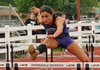 Anna Nastasi of Fayetteville High School competes in the 100-meter hurdles April 12 during the Joe Roberts Relays at Southwest Junior High School in Springdale.
