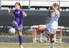 Nina Yeogiants, left, of the Lady Bulldogs tries to turn a ball away from the Lady Panthers’ Sami Abbey on Monday at Glen Black Stadium in Siloam Springs.