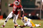 Arkansas wide receiver Joe Adams tries to slip out of a tackle attempt from Tennessee defensive back Byron Moore during the third quarter at Donald W. Reynolds Razorback Stadium in Fayetteville on Saturday, Nov. 12, 2011.