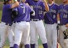 Connor Roberts, center left, Fayetteville senior, is congratulated at the plate Wednesday after hitting a solo home run in the fifth inning of play against Rogers High in Fayetteville.
