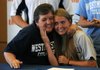 Ashley Schimmel, right, hugs her mother, Kathy Schimmel, Wednesday during a signing ceremony at Rogers Heritage High School. Ashley Schimmel, who played keeper and midfielder for the Lady War Eagles, committed to Westminster College in Missouri.