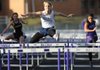 Payton Stumbaugh of Springdale Har-Ber clears the final hurdle on her way to first place Thursday in the girl’s 100-meter hurdles during the 7A-West Conference track meet at Mountie Stadium in Rogers. Stumbaugh set a conference meet record with a time of 14.84 seconds. 