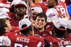 Former Arkansas defensive end Jake Bequette (holding the Cotton Bowl trophy) might have had an inkling that he would be selected by the New England Patriots in the NFL Draft. 