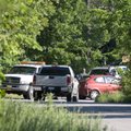 A red car involved in a shooting is hooked to a tow truck on High Sky Inn Road, Tuesday, May 2, 2012...
